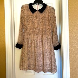 Pink and black patterned dress with black collar and cuffs.